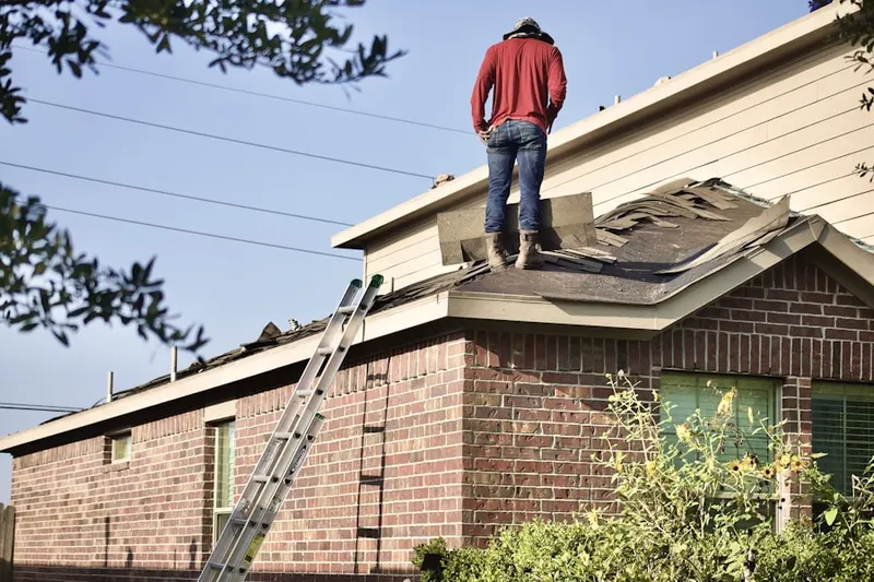Professional roofer working on a residential roof in Old Town